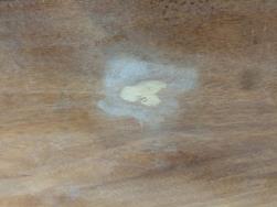 The dent sanded to bare wood.